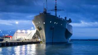 A U.S. Naval ship in port. | Photo 84986290 © | Dreamstime.com